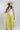 Woman wearing a white sleeveless top and Striped Midi Skirt with Elastic Waist - Lime with a blush flat brim hat and squash blossm necklace-FleaStyle