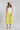 Woman wearing a white sleeveless top and Striped Midi Skirt with Elastic Waist - Lime with a blush flat brim hat and squash blossm necklace-FleaStyle