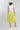 Woman wearing a white sleeveless top and Striped Midi Skirt with Elastic Waist - Lime with a blush flat brim hat and squash blossm necklace-FleaStyle