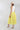 Woman wearing a white sleeveless top and Striped Midi Skirt with Elastic Waist - Lime with a blush flat brim hat and squash blossm necklace-FleaStyle