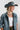 A woman wearing a light blue denim jacket, a matching wide-brim cowboy hat, and a statement necklace featuring chunky ivory beads mixed with antiqued silver-tone geometric beads   for a perfectly collected, lived-in feel-Vintage_Ivory_and_Silver_Chunky_Beaded_Necklace-FleaStyle