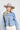 Woman wearing a cropped denim shacket styled with fringe vest and light gray cowboy hat-FleaStyle
