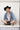 Woman wearing a black cowboy hat, denim jacket, vintage boots and a Upcycled Vintage Tie Necklace-Blush with a gold chain and a one-of-a-kind vintage brooch-Fleastyle, -Fleastyle
