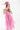 Woman wearing a pink Tiered Ruffle Midi Dress wtih  pink floral and butterfly facinator-FleaStyle