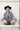 Woman wearing a denim jacket, black hat, Upcycled Vintage Tie Necklace - Fringe and boots-Fleastyle