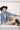 Woman wearing a denim jacket, black cowboy hat, Upcycled-Vintage-Tie-Necklace-Gray and boots-Fleastyle