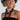 A woman wearing a black straw cowboy hat, a black strapless top, and a long black beaded necklace with silver-toned accents-Vintage Black + Lucite Statement Necklace