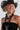 A woman wearing a black straw cowboy hat, a black strapless top, and a long black beaded necklace with silver-toned accents-Vintage Black + Lucite Statement Necklace