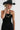 A woman wearing a black cowboy hat and a bold necklace with sculptural, and a little industrial, oversized antiqued silver-tone beads with stacked black disc details and smaller dark beads--Vintage_Black_Silver_Sculptural_Bead_Necklace-FleaStyle
