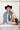 Woman wearing a denim jacket, black cowboy hat, Upcycled-Vintage-Tie-Necklace-Dark-Green and colorful boots-Fleastyle