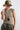 A woman wearing an olive green trucker hat with a butterfly patch, an olive green short-sleeve top, camouflage pants and a  Vintage Oversized Stone Pendant Necklace-FleaStyle