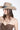 Woman wearing a decorated beige cowboy hat and Oversized Gold Horseshoe Pendant Necklace-FleaStyle