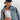 A woman wearing a navy blue trucker hat with a red and blue embroidered butterfly patch, a light-wash denim jacket, a white ribbed tank top, and a patterned camo pants-Butterfly-Patch-Trucker-Hat-Navy-FleaStyle