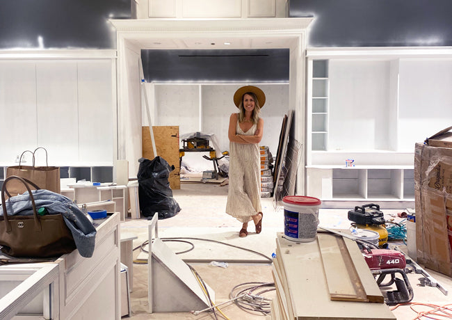 Woman standing inside of a store under construction