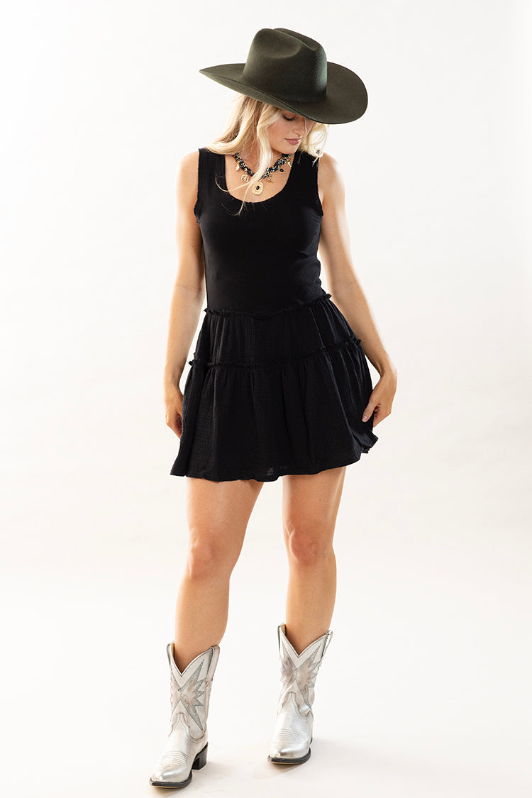 Woman wearing a black dress, black cowboy hat, and silver cowboy boots-Flea Style