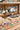 Trucker hat patch bar at The Original Hat Bar with patches, feathers, pins, and accessories laid out for personalized custom trucker hats, linking to book a reservation