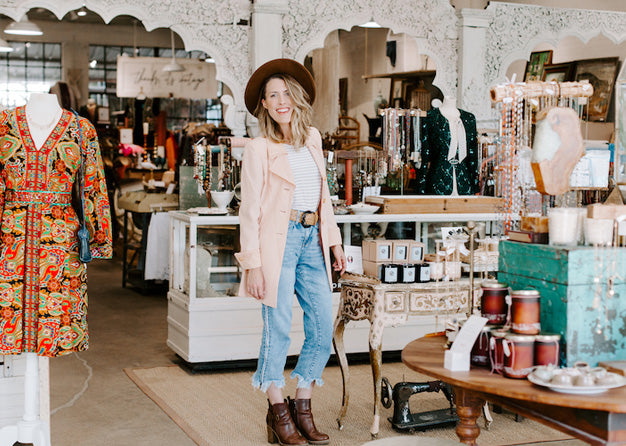 Woman posing inside of a clothing boutique 