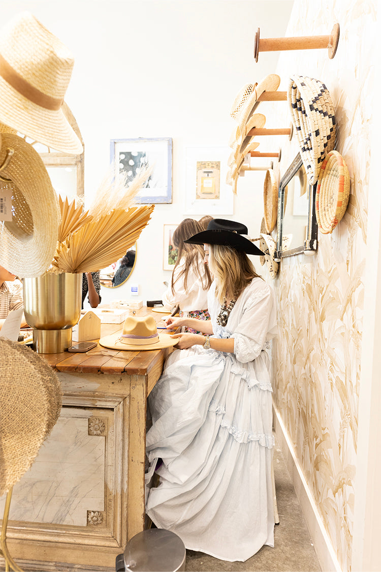 A woman making a hat during a reservation at the Hat Bar